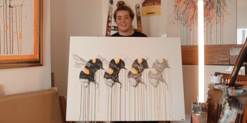Artist Sophie Long holding up her artwork for Cabot Conversations